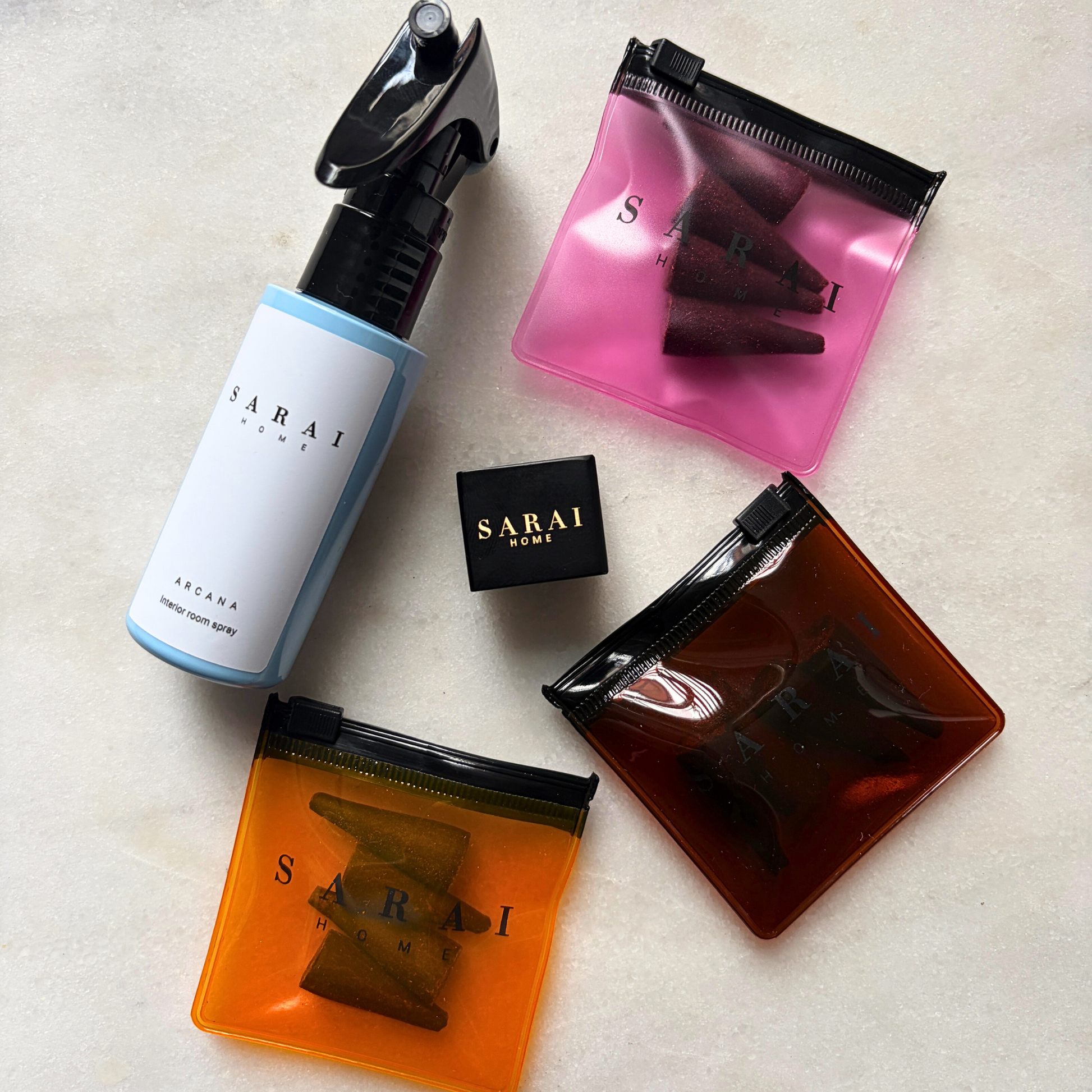 Collection of SARAI home oud fragrance products including an interior spray, incense cones and burner