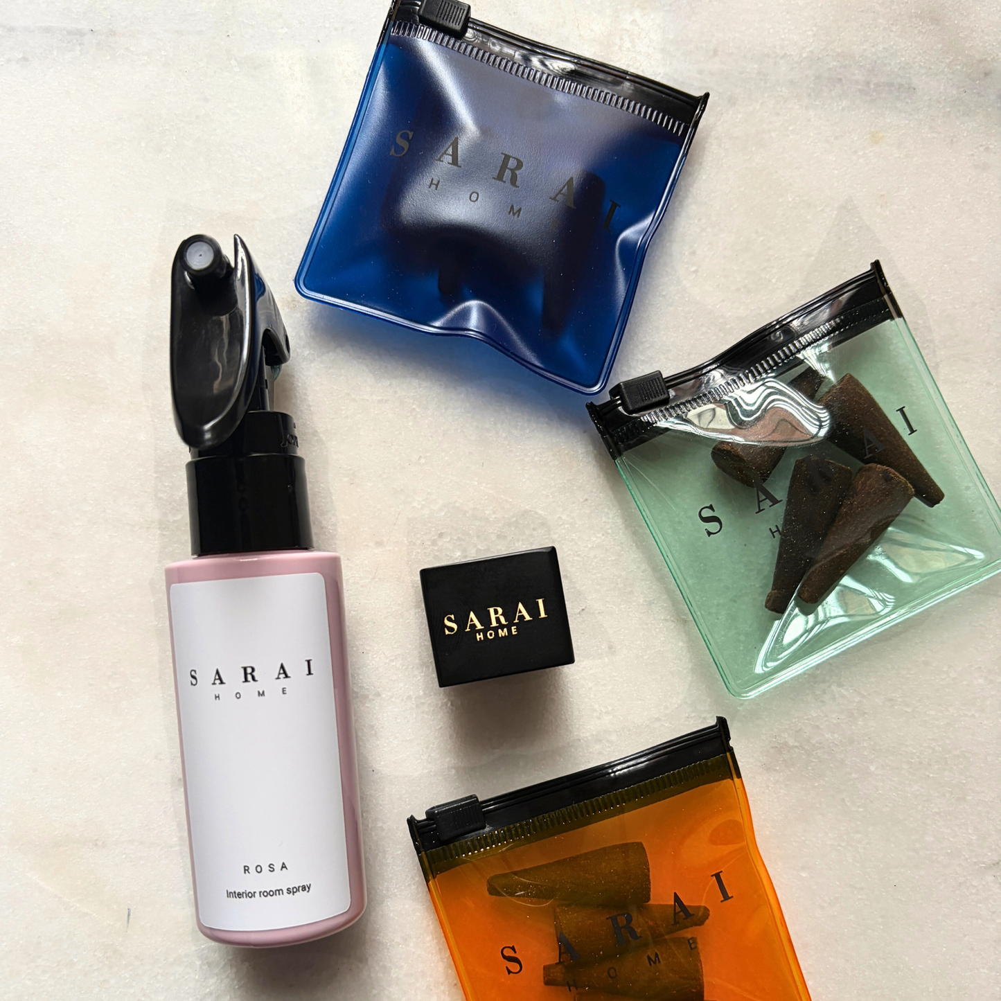 Collection of SARAI home oud fragrance products including an interior spray, incense cones and burner