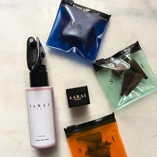 Collection of SARAI home oud fragrance products including an interior spray, incense cones and burner